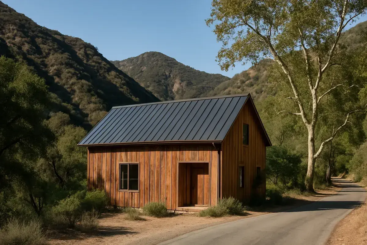 Rustic wood-sided home with a dark standing-seam metal roof in a chaparral canyon in Topanga